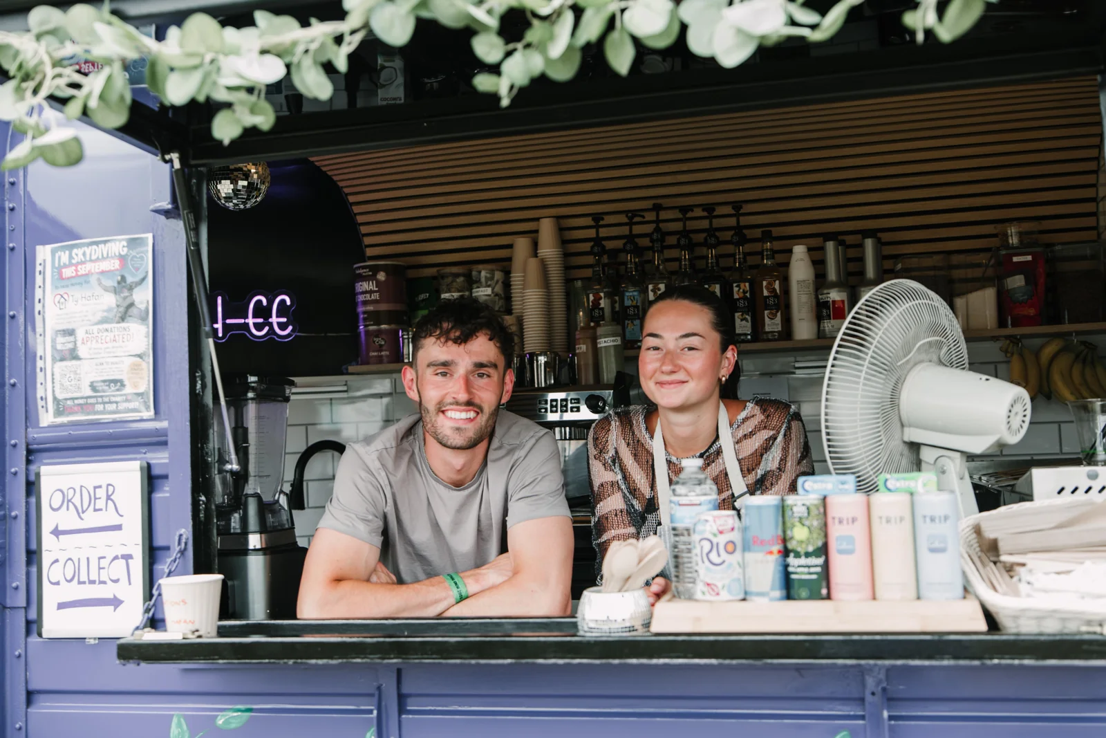 Max and Erin smiling behind the horsebox counter